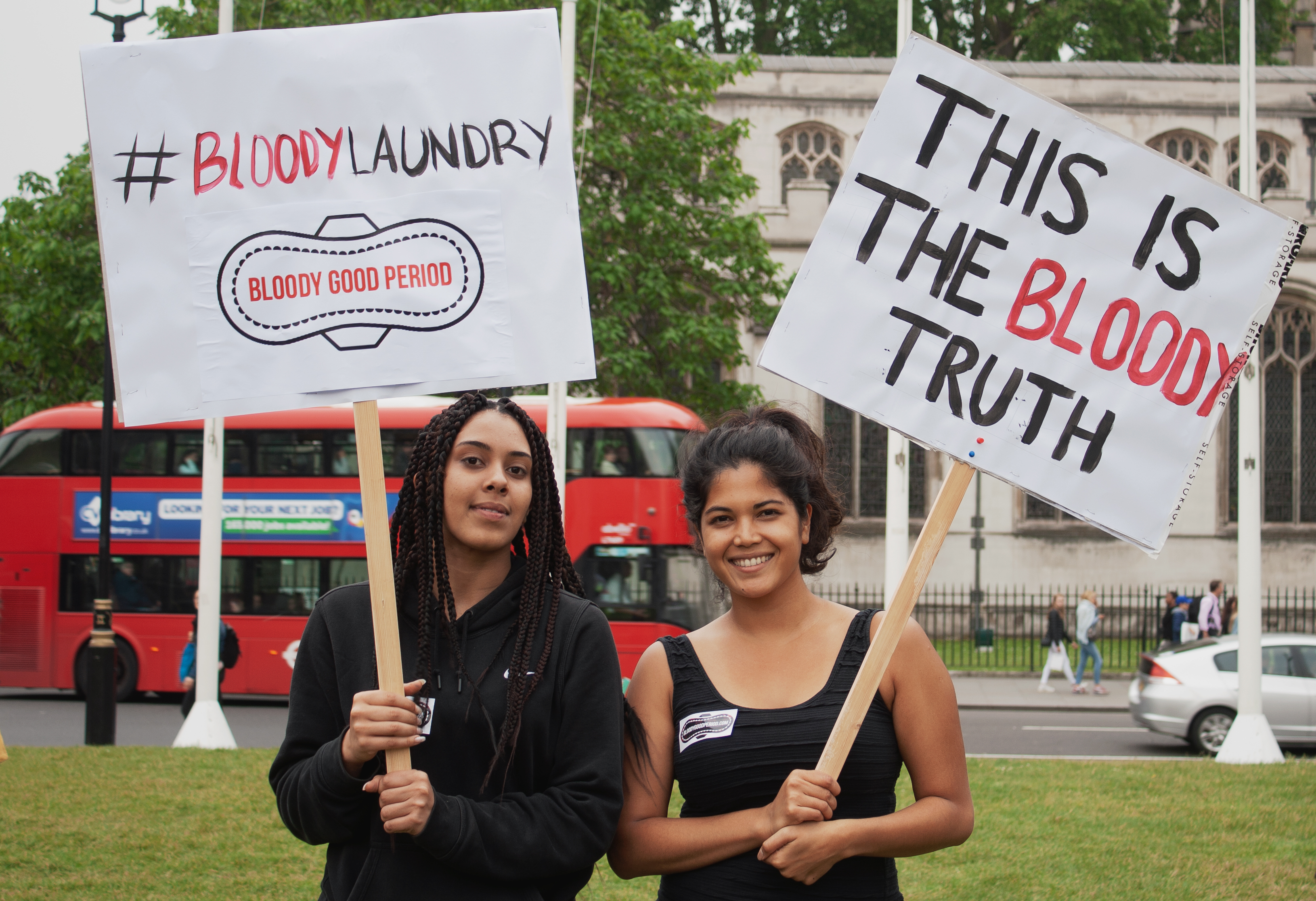 period poverty campaigners with signs