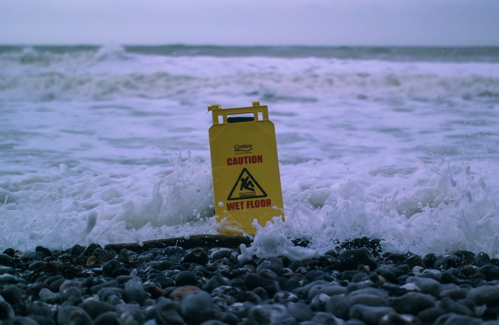 caution wet floor sign in the sea