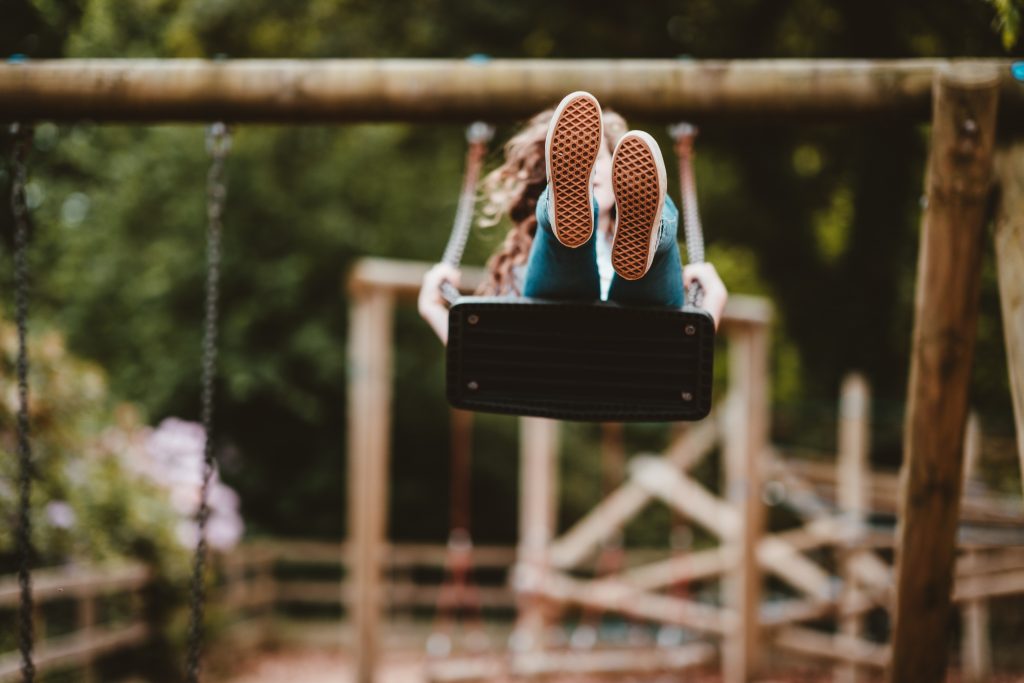a girl on a swing, to highlight the importance of the right to play