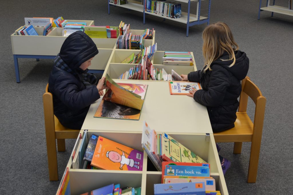 Children reading in a library to illustrate a schoolgirl challenging Northamptonshire County Council's proposal to shut 21 out of 36 libraries (Aug 15, 2018)