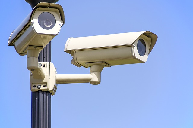 Two surveillance cameras, facial recognition monitoring.