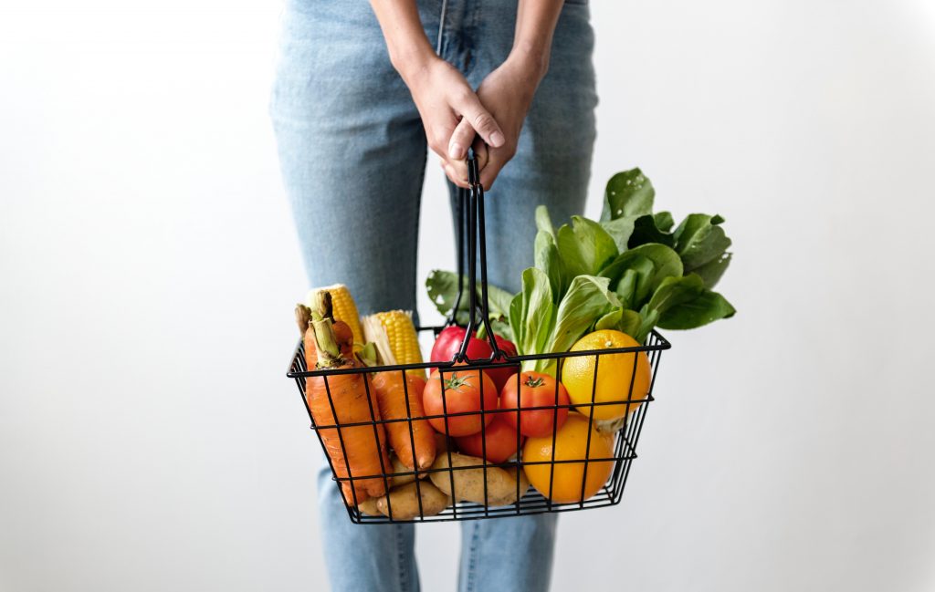 https://www.pexels.com/photo/woman-carrying-basket-of-fruits-and-vegetables-1389103/