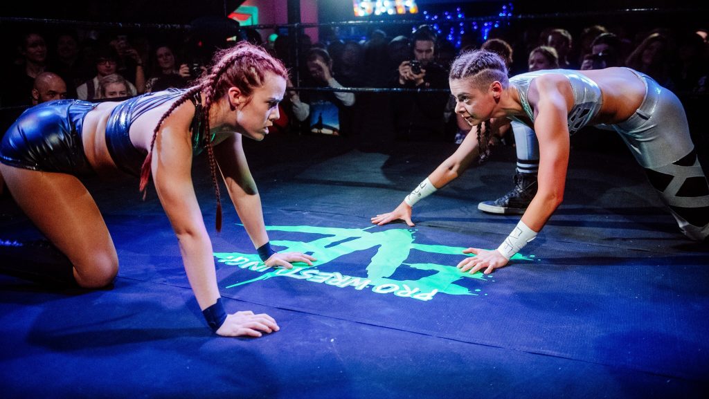Two women wrestle